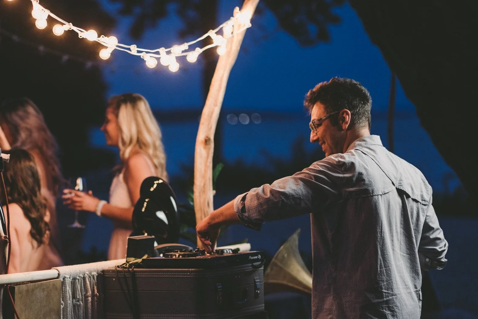 DJ Marinko performing at an event, seen from behind the DJ booth